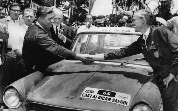 18th April 1963: Nick Nowicki and Paddy Cliffe, winners of the East African Safari Rally race in Kenya, shake hands over the bonnet of their Peugeot 404