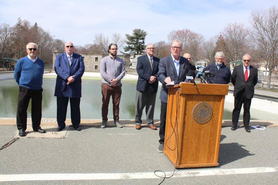 Cranston Mayor Ken Hopkins, flanked by members of his administration, holds a news conference at the Budlong Pool on Monday.