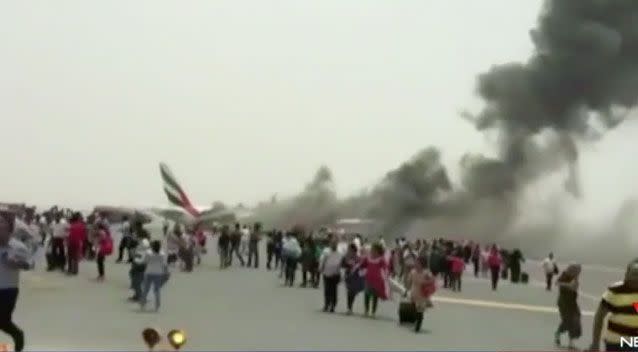 In August an Emirates plane caught fire and many stopped to grab belongings before evacuating. Photo: 7 News