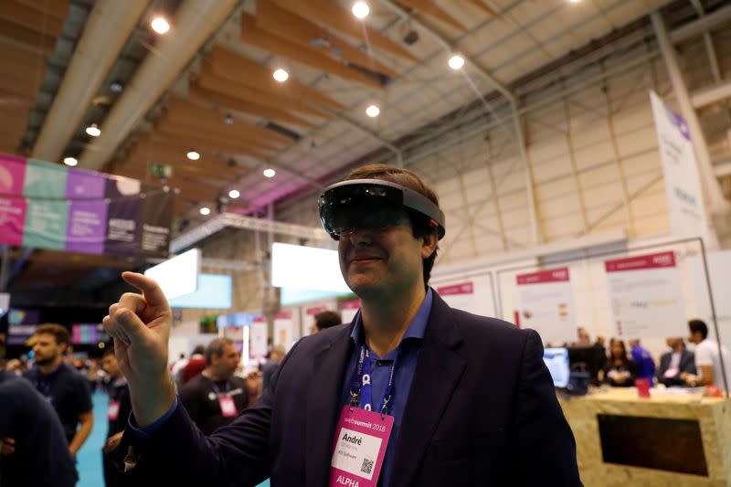 FILE PHOTO: A visitor wears virtual reality glasses during the Websummit in Lisbon, Portugal