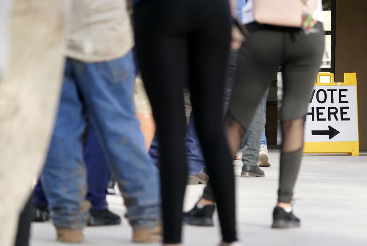 Voters wait to cast their ballot on Election Day at the Pendergast Learning Center in Phoenix.