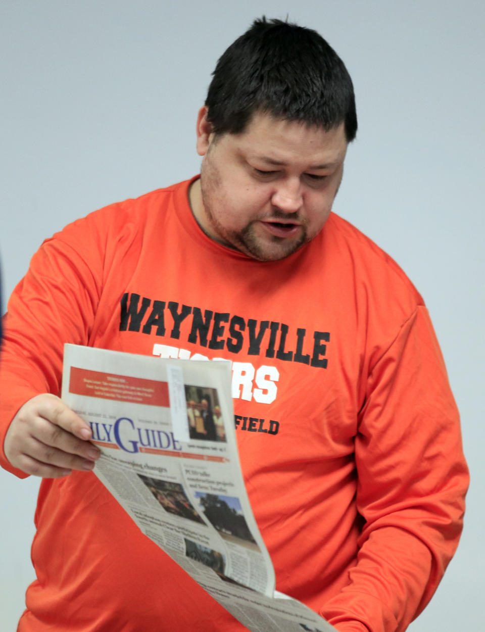 In this Feb. 20, 2019 photo, Allen Hilliard looks over old copies of the Daily Guide at the library in Waynesville, Mo. (AP Photo/Orlin Wagner)