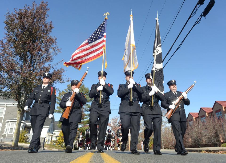 The Brockton Fire Department Color Line marches in the Brockton Veterans Day Parade on Thursday, Nov. 11, 2021.