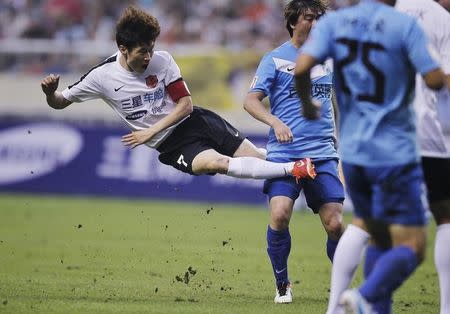 South Korean soccer player Park Ji-sung (L) of the Park Ji-sung and Friends team fights for the ball with players of the Shanghai Laokele Stars during a charity soccer match at the Shanghai Hongkou Stadium in Shanghai, June 23, 2013. REUTERS/Aly Song/Files