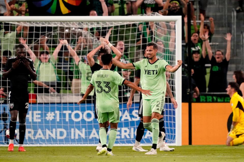 Austin FC midfielder Owen Wolff congratulates defender Matt Hedges on a goal scored against D.C. United in the second half at Q2 Stadium on Wednesday.