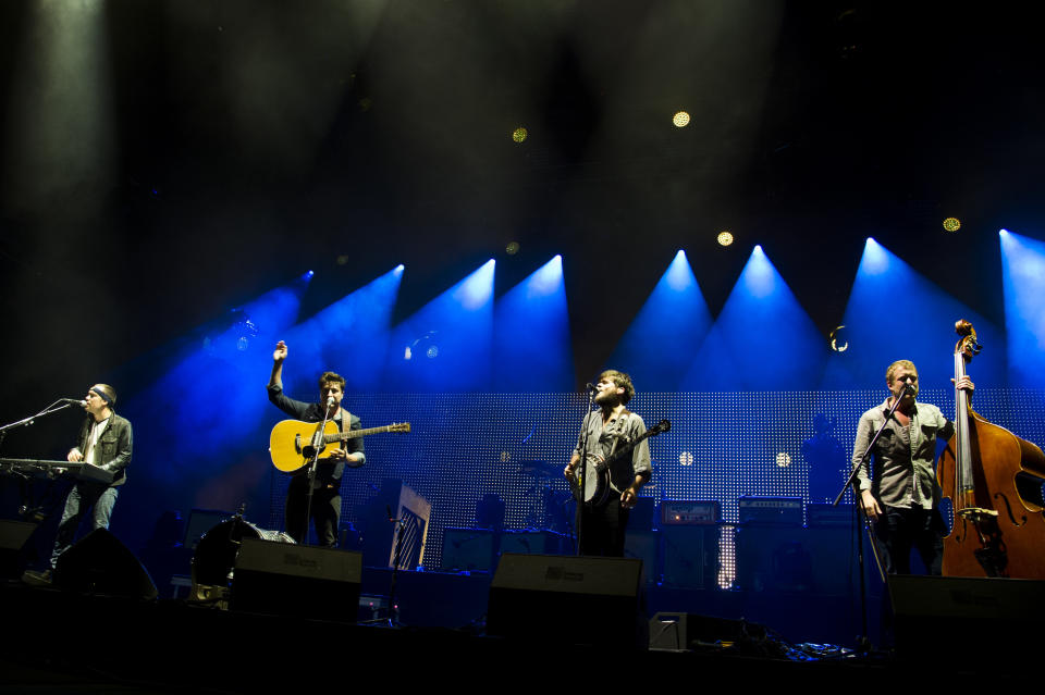 Mumford & Sons band members, from left, Ben Lovett, Marcus Mumford, Country Winston and Ted Dwane perform on Wednesday, Aug. 28, 2013 at the West Side Tennis Club in the Forest Hills neighborhood of the Queens borough of New York. (Photo by Charles Sykes/Invision/AP)