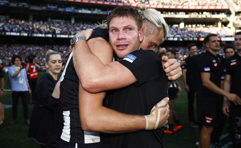Taylor Adams, pictured here with Darcy Moore after Collingwood's win in the AFL grand final.