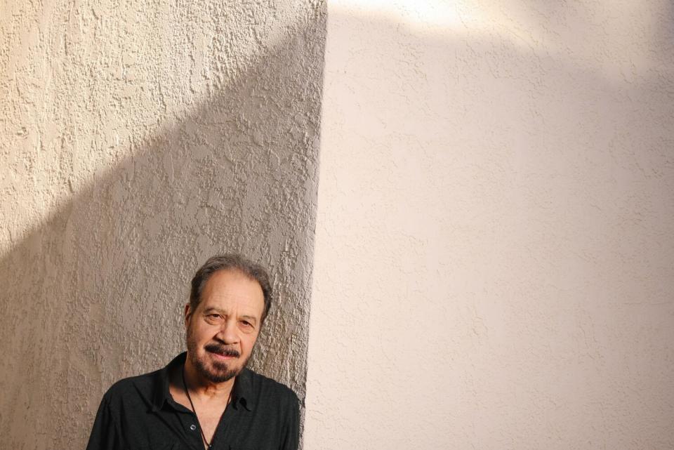 Ed Zwick photographed outside his L.A. office with shadows creeping across the wall.