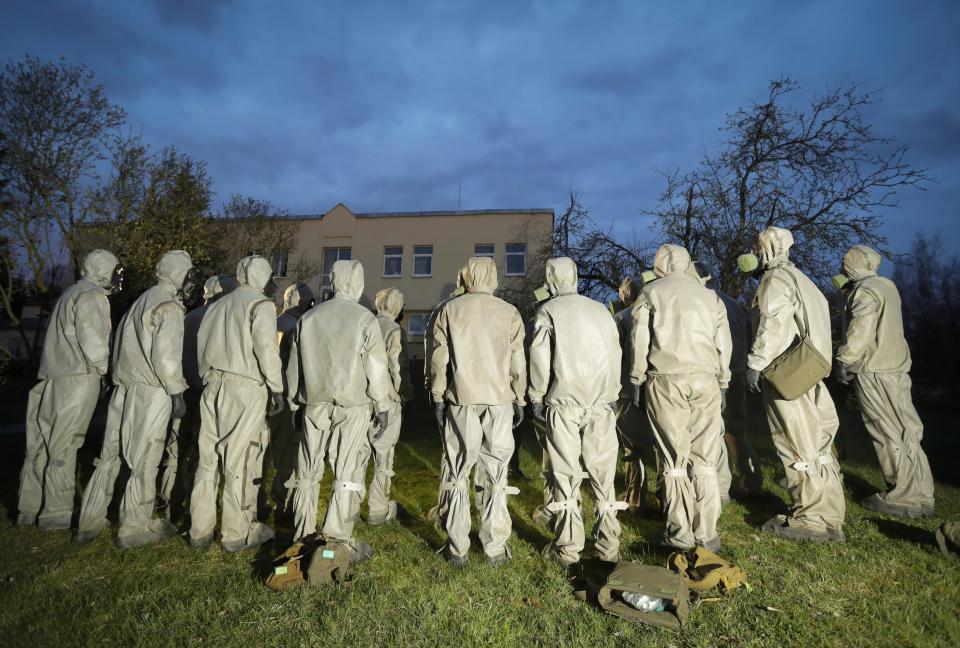 FILE In this file photo taken on Wednesday, April 29, 2020, Servicemen of Belarus Ministry of Defence wearing protective gear prepare to disinfect a local hospital in the town of Zaslavl, outside the capital Minsk, Belarus. The 9.5-million Belarus has reported more than 68,500 infections, including 580 deaths. Critics have accused the authorities of manipulating statistics to hide the real number of deaths. (AP Photo/Sergei Grits, File)