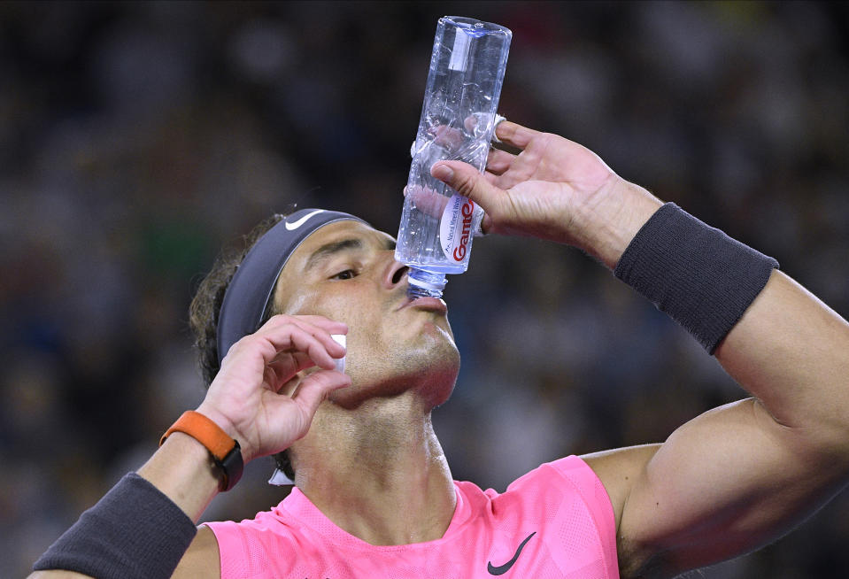 Spain's Rafael Nadal takes a drink during a break in his fourth round match against Australia's Nick Kyrgios at the Australian Open tennis championship in Melbourne, Australia, Monday, Jan. 27, 2020. (AP Photo/Andy Brownbill)