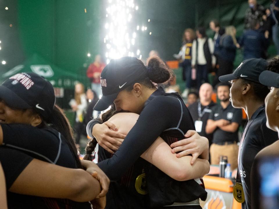 The Carleton Ravens celebrate their victory over the Queen's Gaels in the U Sports women's basketball national championship in Sydney, N.S., on Sunday. (Shane Wilkie/The Canadian Press - image credit)