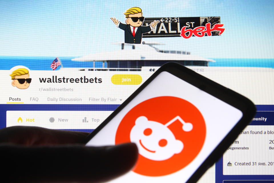 UKRAINE - 2021/02/08: In this photo illustration a Reddit logo is seen on a cell phone screen in front of the WallStreetBets (WSB) logo of a subreddit where participants discuss stock and options trading.  (Photo illustration by Pavlo Gonchar/SOPA Images/LightRocket via Getty Images)