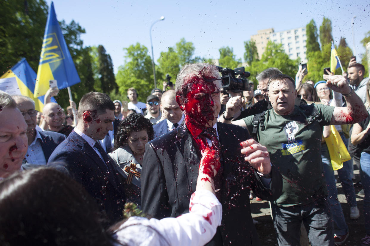 Russian Ambassador to Poland, Ambassador Sergey Andreev is covered with red paint in Warsaw, Poland, Monday, May 9, 2022. Protesters have thrown red paint on the Russian ambassador as he arrived at a cemetery in Warsaw to pay respects to Red Army soldiers who died during World War II. Ambassador Sergey Andreev arrived at the Soviet soldiers cemetery on Monday to lay flowers where a group of activists opposed to Russia’s war in Ukraine were waiting for him. (AP Photo/Maciek Luczniewski)