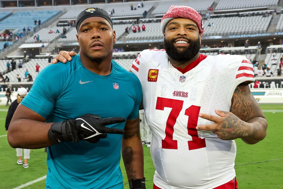 Travon Walker #44 of the Jacksonville Jaguars poses with Trent Williams #71 of the San Francisco 49ers during the game at EverBank Field on November 12, 2023 in Jacksonville, Florida. (Photo by Mike Carlson/Getty Images)