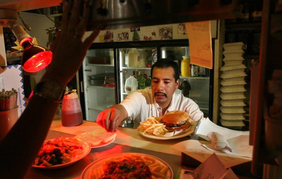 The longtime cook at Uncle Harry’s, Genaro Lozano, makes room for another lunch plate in this Fresno Bee file photo from 2006.