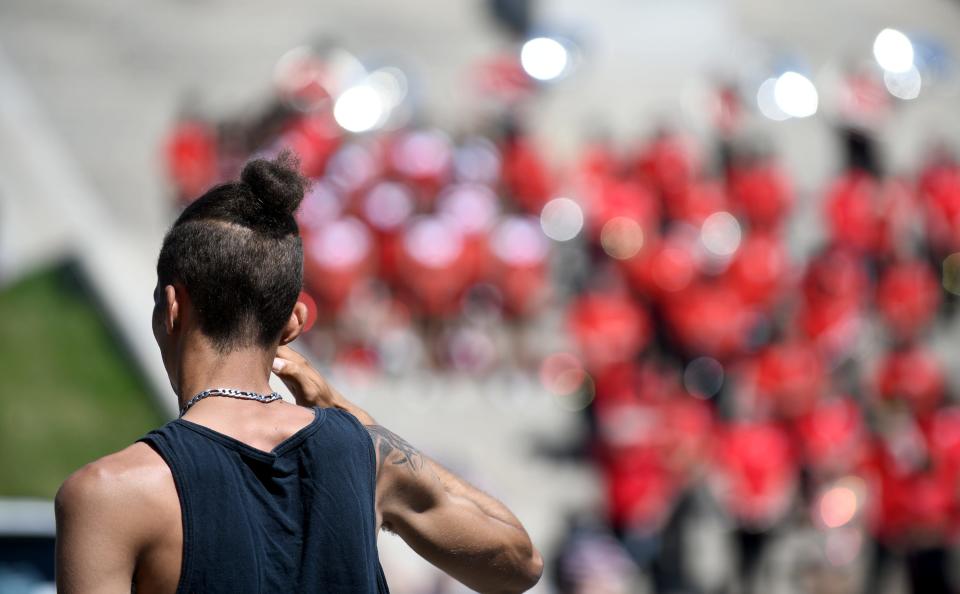 Army veteran Ty Hill salutes Monday during the playing of Taps to end the Canton Memorial Day Parade and Ceremony.