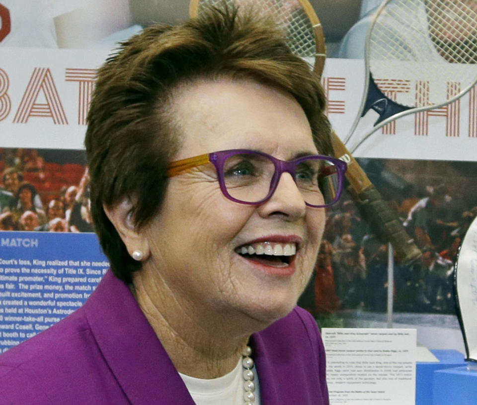 FILE - In this Sept. 5, 2013, file photo, Billie Jean King reflects about her match against Bobby Riggs in 1973 as she stands in front of a display at the U.S. Open tennis tournament in New York. King watched the gold-medal hockey game won by Canada, greeted U.S. athletes and met with a Russian gay teenager in her whirlwind three days at the Sochi Olympics. She'd like the IOC to add sexual orientation to its charter and consider the issue when deciding host countries for future Olympics. (AP Photo/Darron Cummings, File)