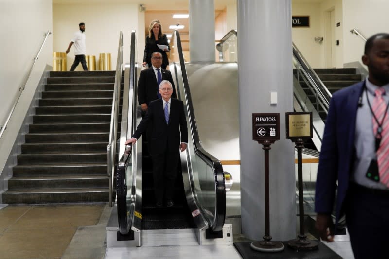 U.S. Senate Majority Leader Mitch McConnell (R-KY) descends down an escalator ahead of a series of votes on response for the coronavirus disease (COVID-19), on Capitol Hill in Washington