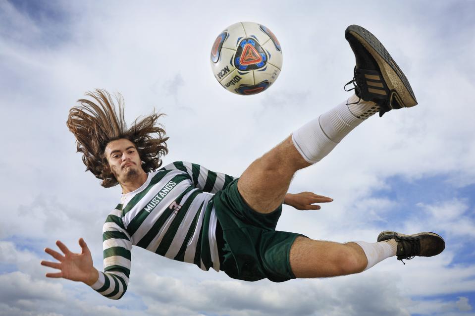 Mandarin senior Sasha Maric makes an acrobatic scissors kick at The Corral.