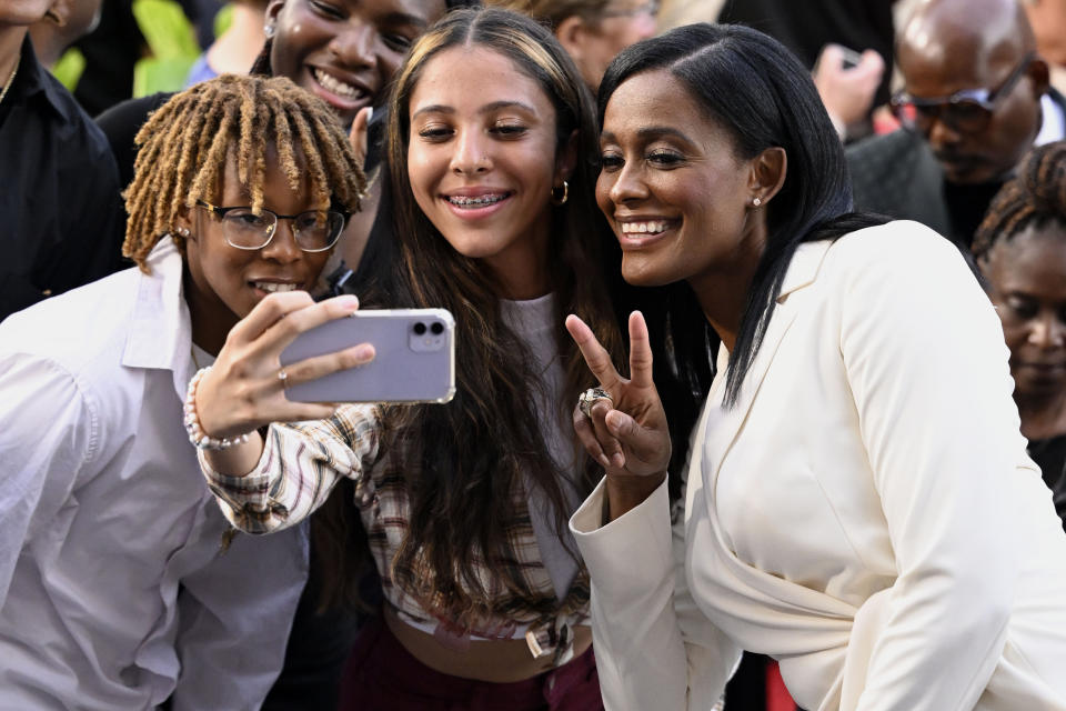 Swin Cash, right, poses for photos with fans as she arrives for the Basketball Hall of Fame enshrinement ceremony Saturday, Sept. 10, 2022, in Springfield, Mass. (AP Photo/Jessica Hill)