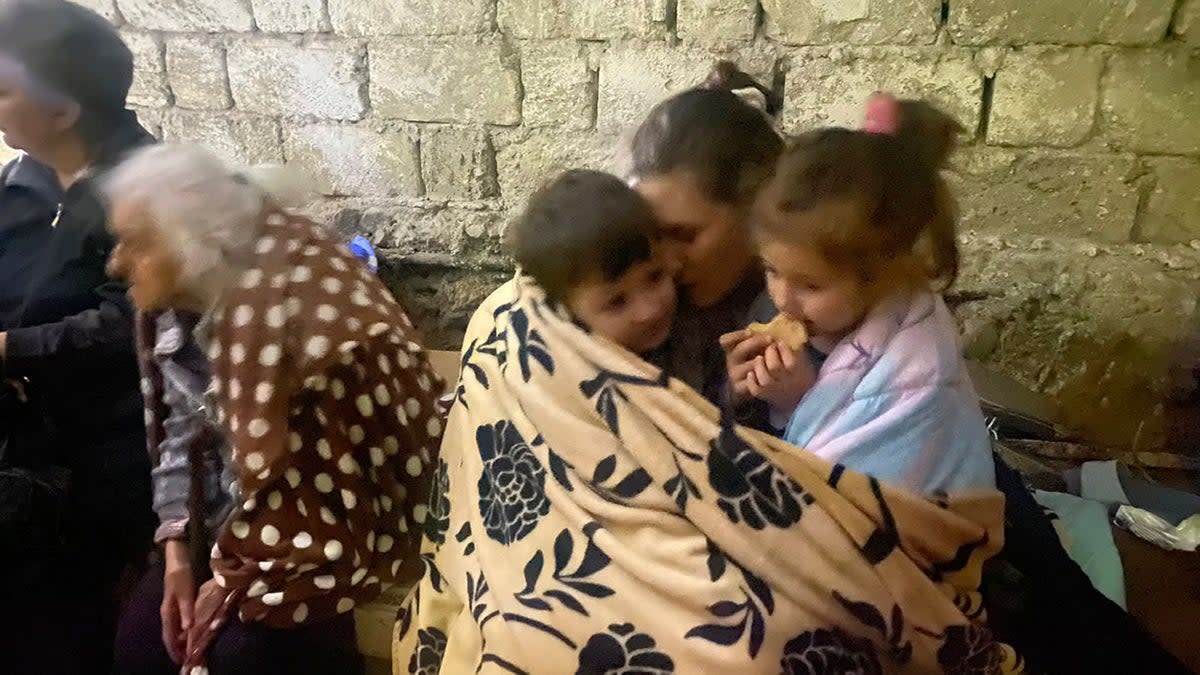 Children eat sitting in a shelter during shelling in Stepanakert in the breakaway territory of Nagorno-Karabakh (AP)