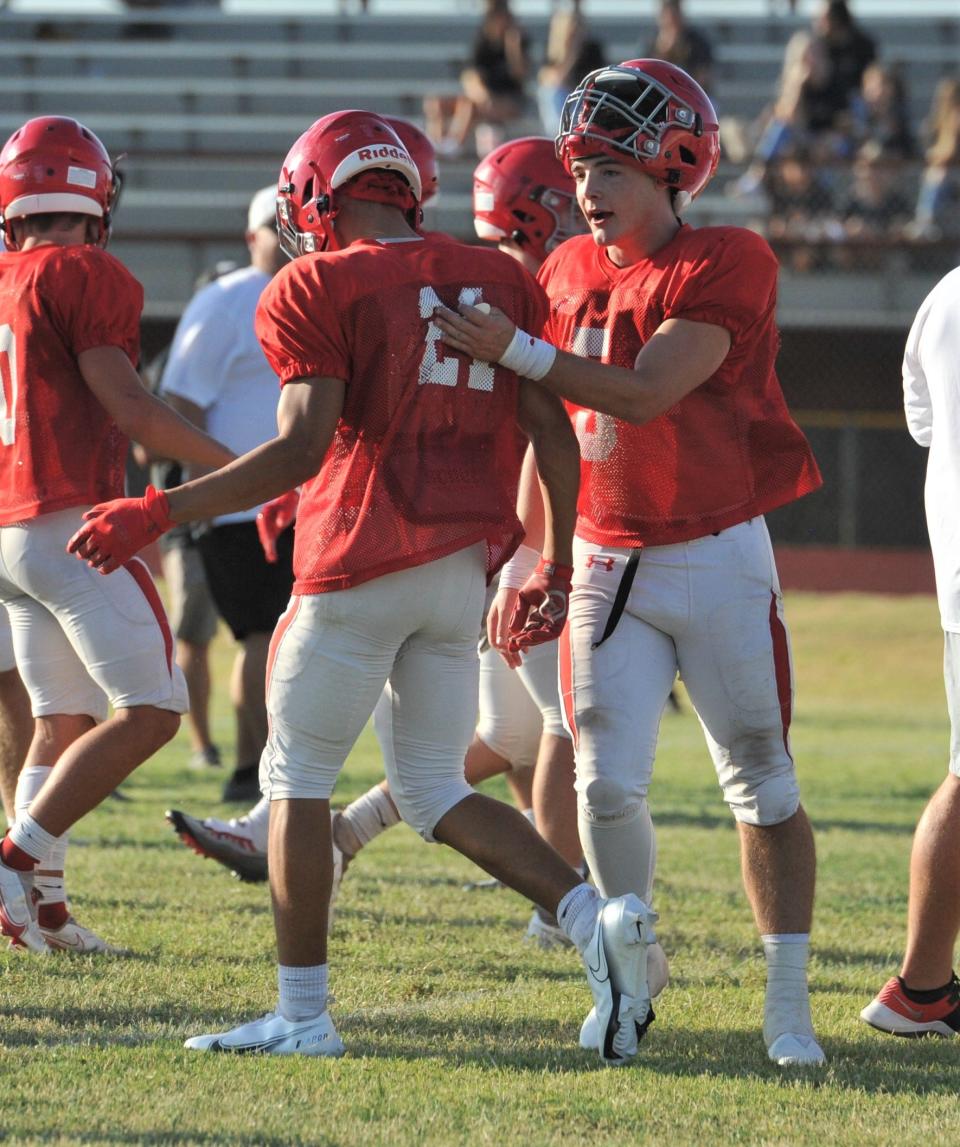 Holliday's Jaxx Johnson (5) pats his teammate on the back after scoring a touchdown during a scrimmage against Cisco on Friday, August 12, 2022.