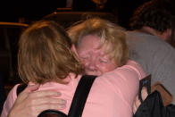 <p>Sunday School director Ann Montgomery was comforted during a candlelight vigil held across the street from the First Baptist Church in Sutherland Springs, Texas. (Getty) </p>