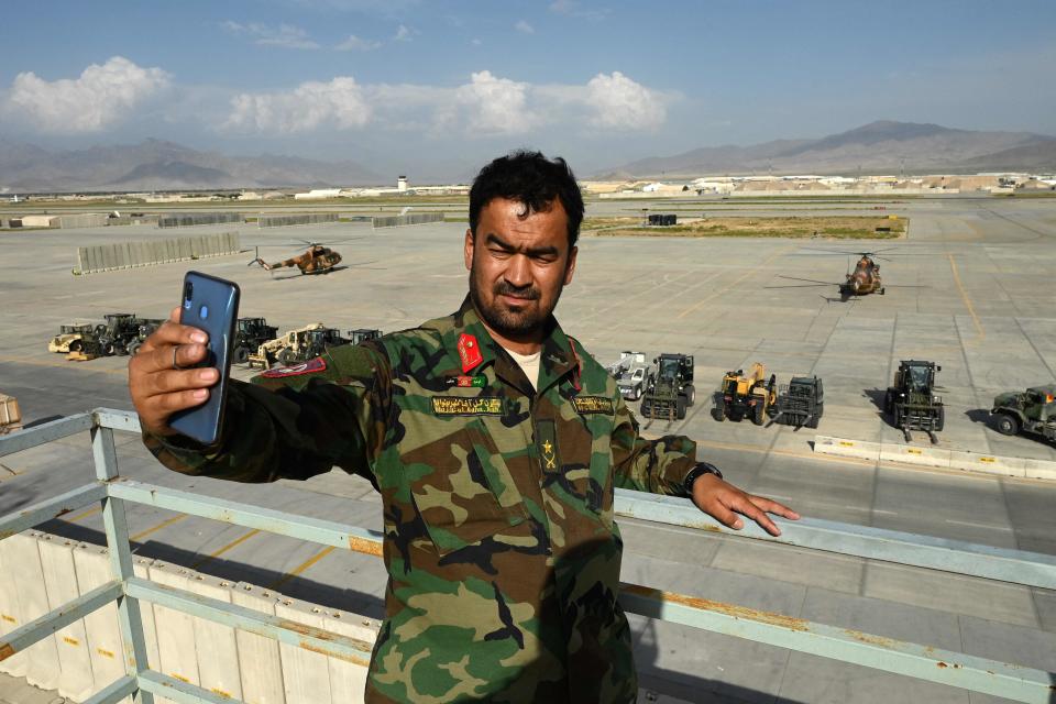 An Afghan National Army soldier takes a selfie with his mobile phone inside the Bagram air base on July 5, 2021, after all U.S. and NATO troops left.