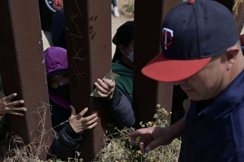 Migrants continue stuck between the Tijuana-San Diego border as some have resorted to calling food and drink services on their phones to eat, while also receiving donations from good samaritans, as many of the migrants are waiting and hoping to be allowed to immigrate to the U.S. more easily after the "Title-42" deportation order expires on May 11, as seen from Tijuana, Mexico. Photo by Carlos Moreno/UPI