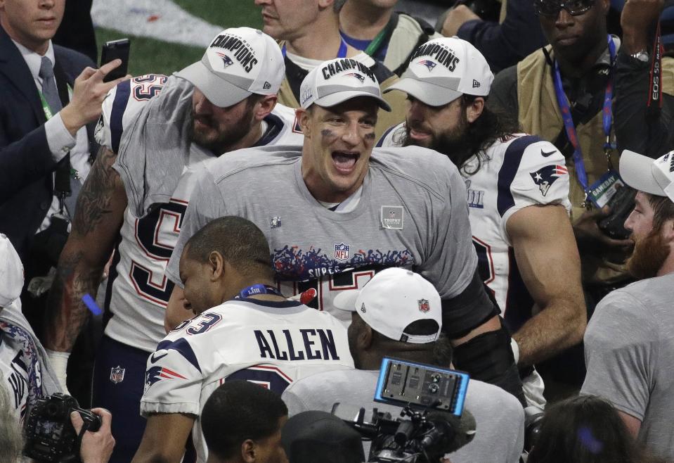 New England Patriots' Rob Gronkowski (87) celebrates with teammates after the NFL Super Bowl 53 football game against the Los Angeles Rams, Sunday, Feb. 3, 2019, in Atlanta. The Patriots won 13-3. (AP Photo/Charlie Riedel)