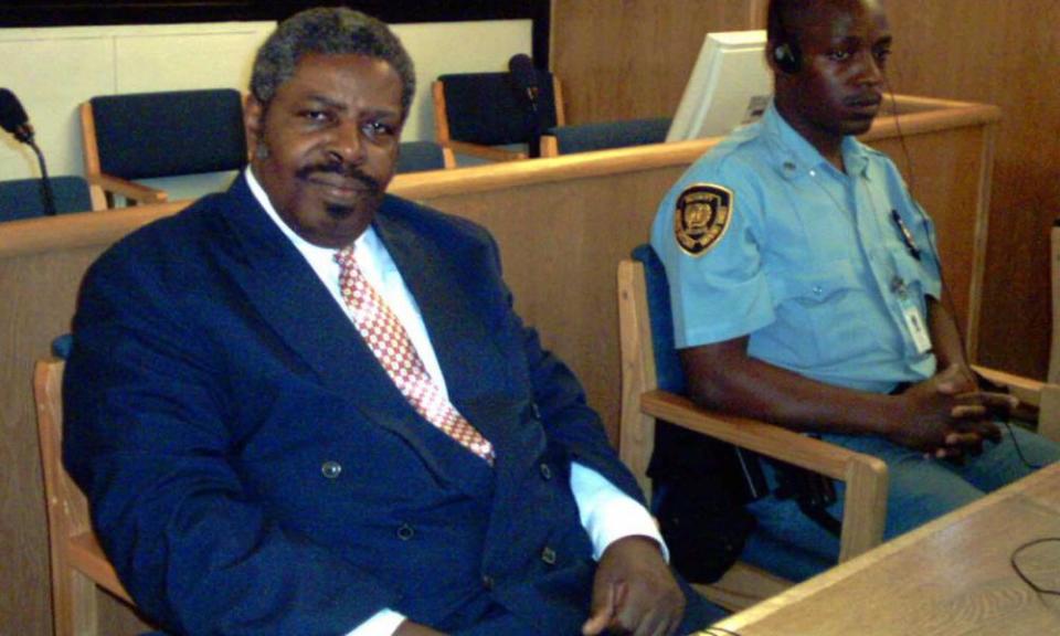 Eliezer Niyitegeka former minister of information in Rwanda sits next to the UN security officer at the 21 April 2004 International Court tribunal for Rwanda (ICTR) in Arusha.