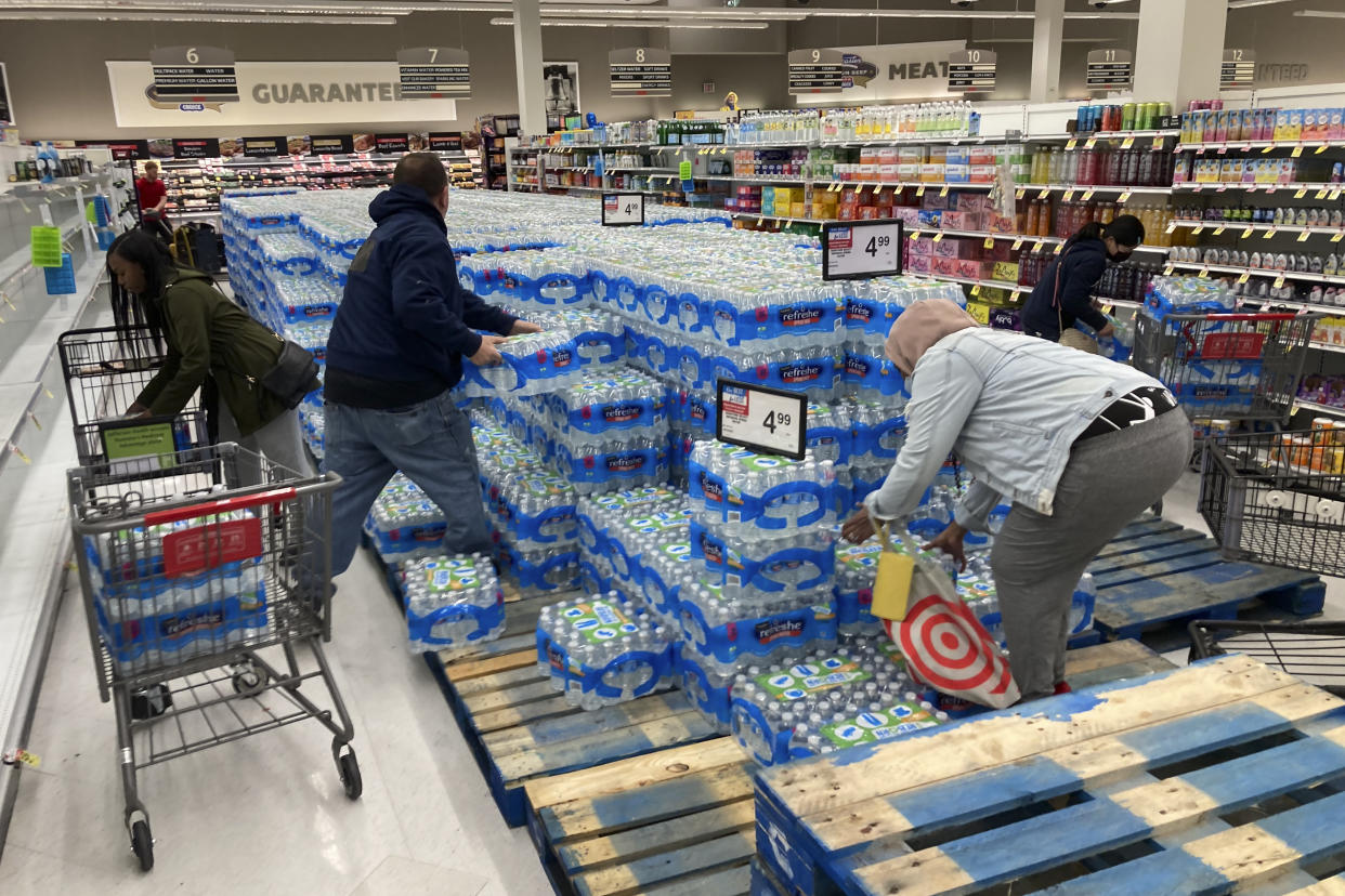 Shoppers stock up on bottle water following a chemical spill into the Delaware River upstream from Philadelphia, Tuesday, March 28, 2023. Health officials in Bucks County, just north of Philadelphia, said Sunday that thousands of gallons of a water-based latex finishing solution spilled into the river late Friday due to a leak at the Trinseo Altuglas chemical facility in Bristol Township. (AP Photo/Matt Rourke)