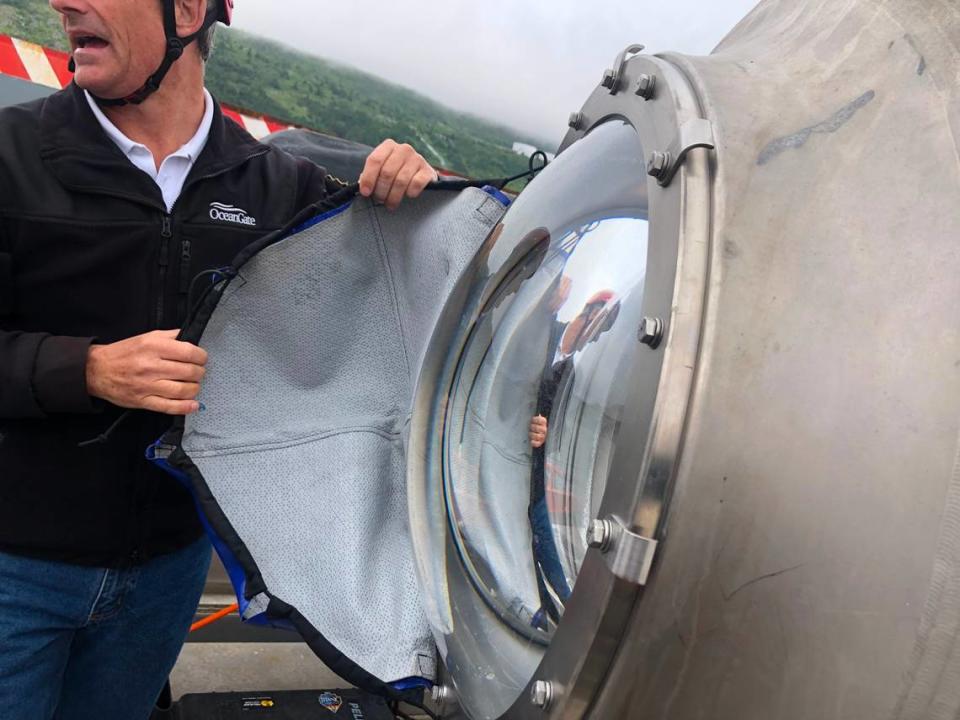 OceanGate CEO Stockton Rush removes the cover from the Titan’s porthole before Bill Price’s trip aboard the vessel in 2021.