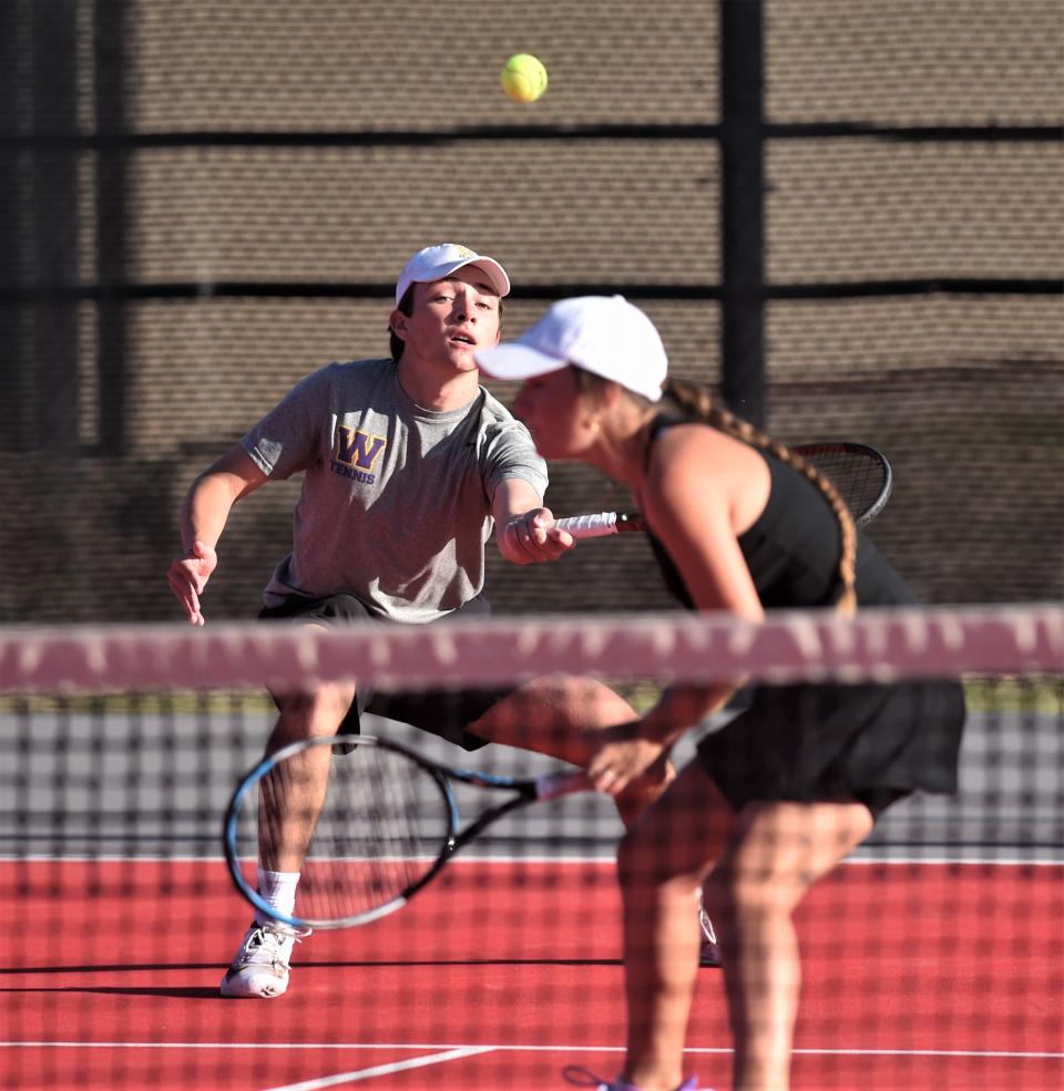 Wylie's Trevor Short plays a ball in front of teammate Stealey Crousen during their mixed doubles final against teammates Marshall McPherson and Carly Bontke. Short and Crousen won the match 6-1, 6-2 to win the Region I-5A title April 11 at Texas Tech's McLeod Tennis Center in Lubbock.