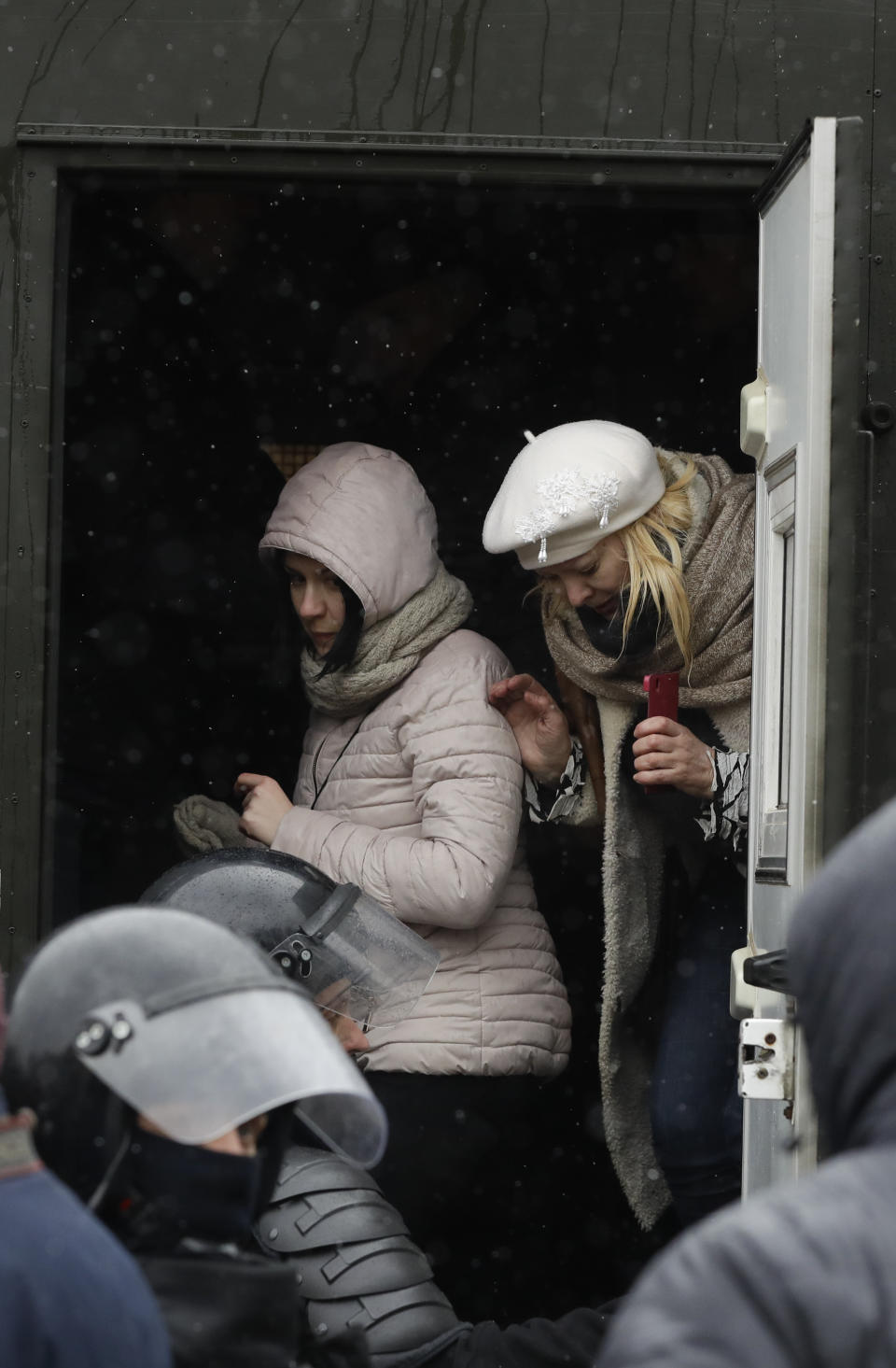 Two women are detained by police during an opposition rally in Minsk, Belarus, Saturday, March 25, 2017. Police in the Belarusian capital have begun wide-scale arrests protesters who had gathered for a forbidden demonstration that they hoped would build on a rising wave of defiance of the former Soviet republic's authoritarian government. (AP Photo/Sergei Grits)