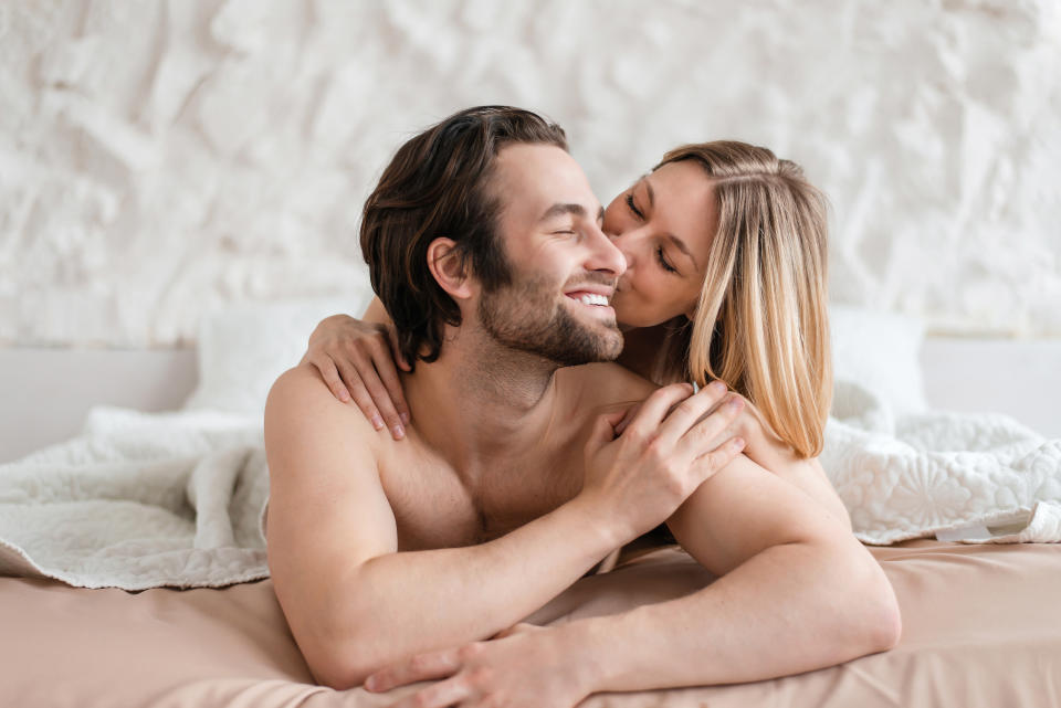 couple kissing in bed