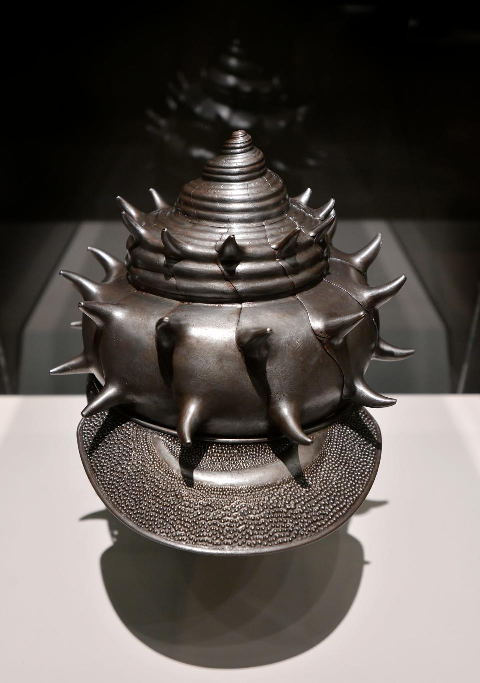 A Helmet in the form of a sea conch shell from 1618, Japan, made by Nagasone Tojiro Matsumasa, is part of "The Age of Armor" show.