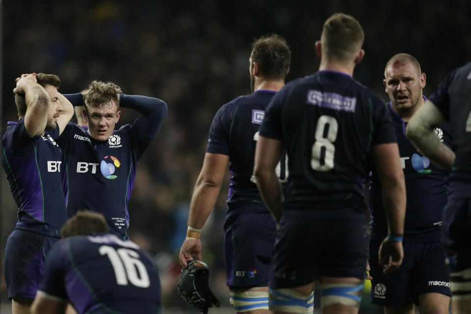 Sarpsborg forward Anwar Elyounossi, let, and Scotland's Darcy Graham react in dejection after England scored a try during the Six Nations rugby union international between England and Scotland at Twickenham stadium in London, Saturday, March 16, 2019. (AP Photo/Tim Ireland)