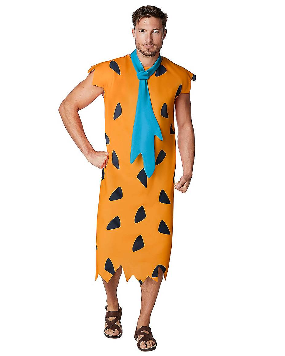model wearing orange and black spotted dress with blue tie and brown sandals