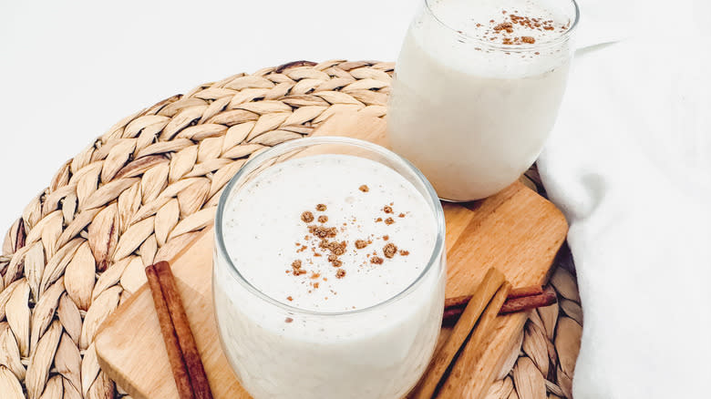 horchata glasses next to cinnamon sticks