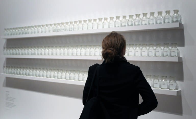 A visitor looks at the work " We are all water" of Yoko Ono during the press visit of her exhibition "half-a-wind show" at the Schirn Kunsthalle in Frankfurt am Main on February 14, 2013. The largest-ever retrospective of works of Yoko Ono, once described by her late husband John Lennon as "the most famous unknown artist in the world", opened in Frankfurt's Schirn Kunsthalle