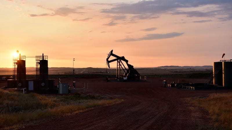 An oil well works at sunrise Aug. 25, 2021, in Watford City, N.D., part of McKenzie County.
