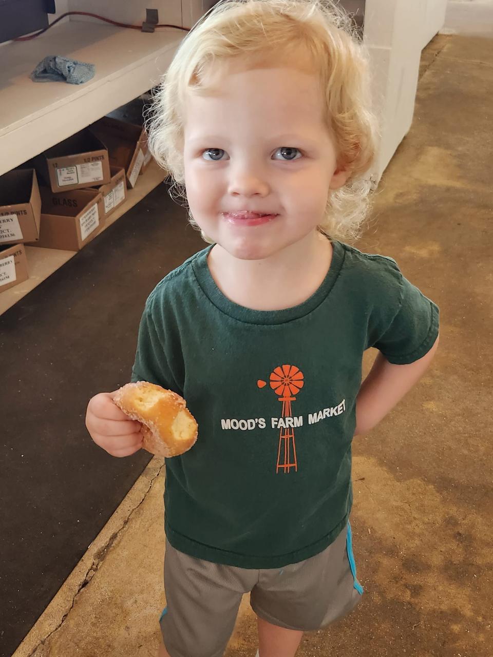 Mood's Farm Market's youngest employee Joey enjoys a donut.