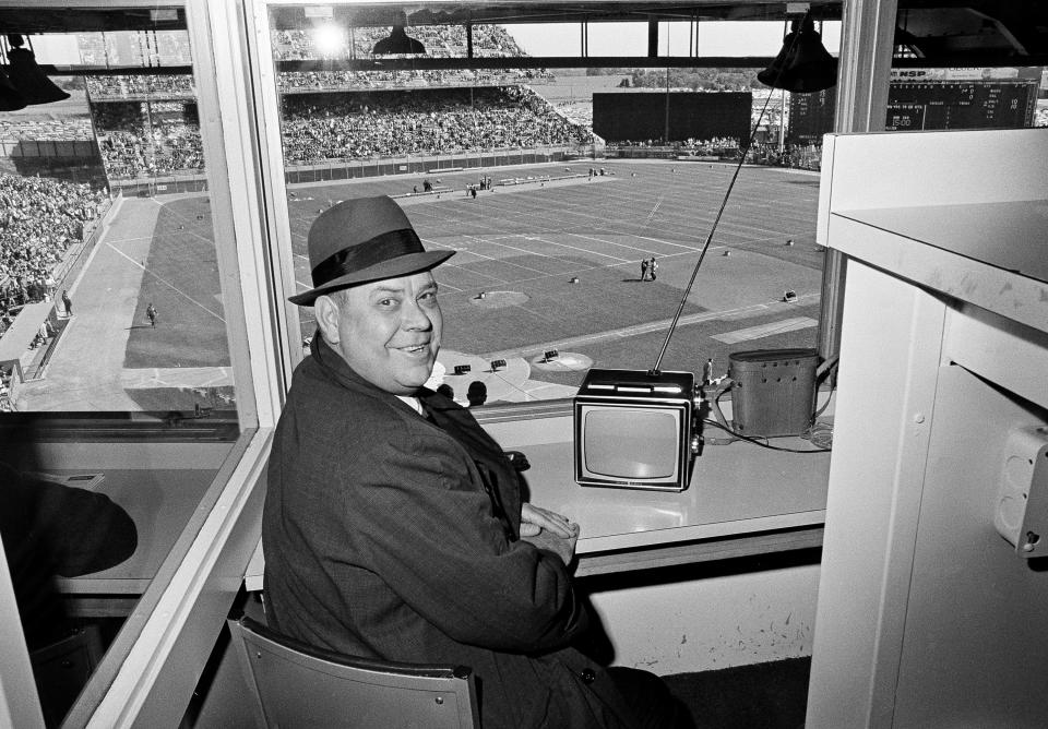 FILE - In this Sept. 26, 1965, file photo, Calvin Griffith, president of the Minnesota Twins, sits in the press box at Metropolitan Stadium watching the Twins on television and awaiting the start of the Minnesota Vikings-Detroit Lions NFL game, in Minneapolis. The Minnesota Twins say they’ve removed a statue of former owner Calvin Griffith at Target Field, citing racist remarks he made in 1978. (AP Photo/Gene Herrick, File)