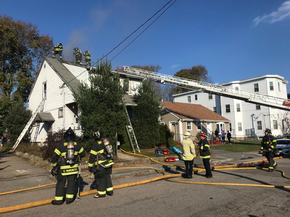 Brockton firefighters battle a fire at a home at 53 Division St. called in at around 12:37 p.m. Wednesday, Nov. 23, 2022.