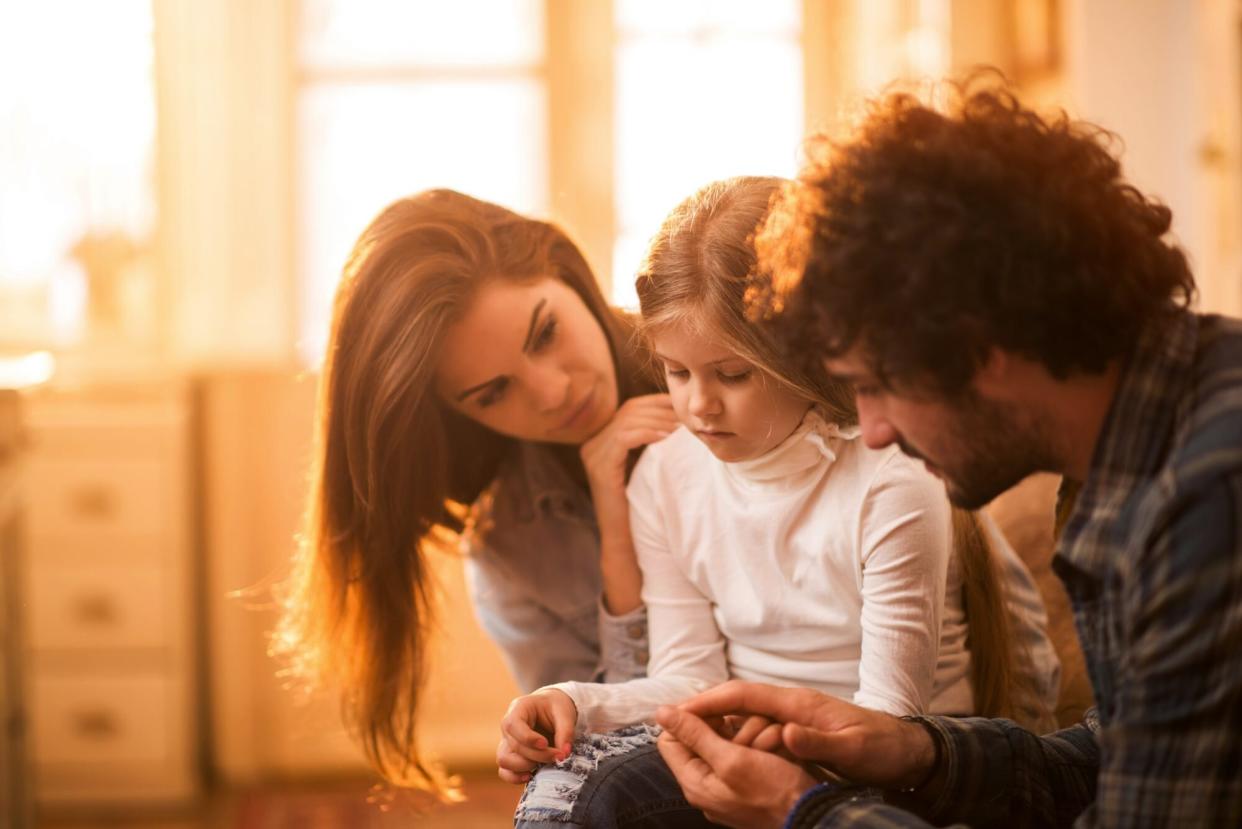 Worried Parents Consoling Daughter