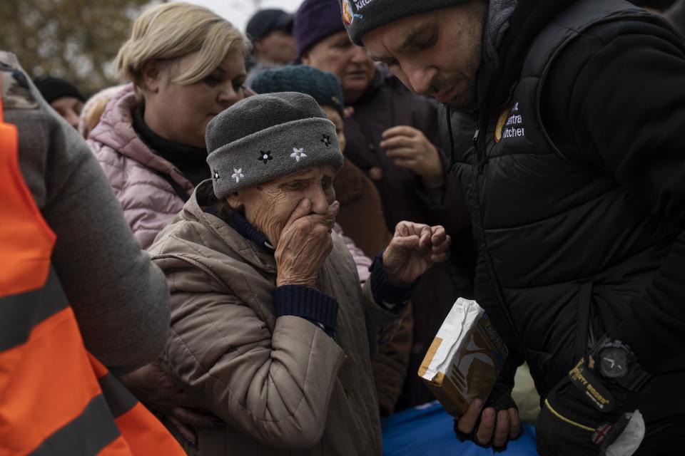 A woman reacts after receiving food donations from World Central Kitchen in Kherson, in southern Ukraine, on Thursday, Nov. 17, 2022. The image was part of a series of images by Associated Press photographers that was a finalist for the 2023 Pulitzer Prize for Feature Photography. (AP Photo/Bernat Armangue)