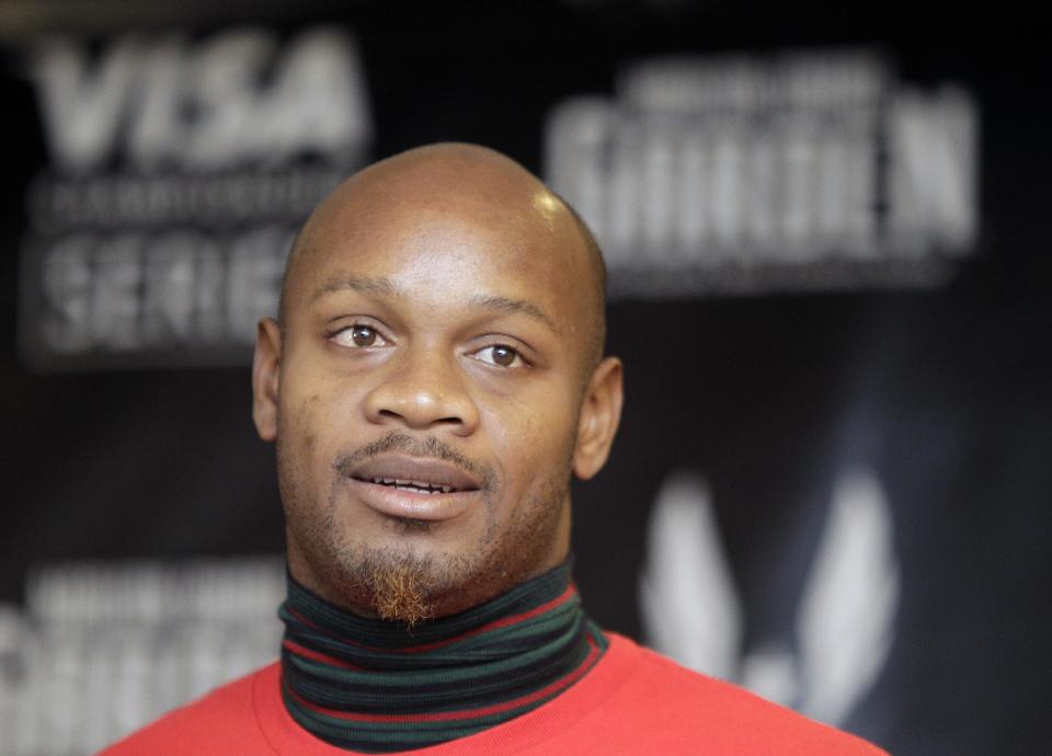 FILe - In this Jan. 26, 2012 file photo, former 100-meter world record holder Asafa Powell listens to reporters' questions during a press conference in New York. Powell has been banned from his sport for 18 months. The 31-year-old sprinter tested positive for the banned stimulant oxilofrone at Jamaica's national trials last June. (AP Photo/Kathy Willens, File)