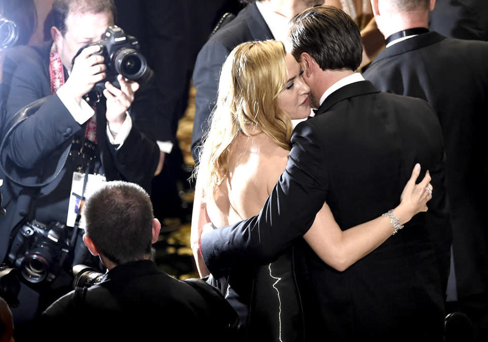 Kate Winslet congratulates Leonardo DiCaprio on stage at the conclusion of the show at the Oscars on Sunday, Feb. 28, 2016, at the Dolby Theatre in Los Angeles. 