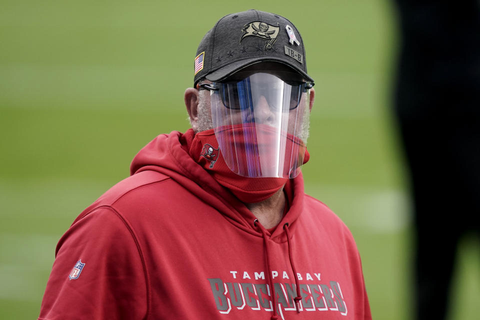 Tampa Bay Buccaneers head coach Bruce Arians walks the turf before the first half of an NFL football game between the Carolina Panthers and the Tampa Bay Buccaneers, Sunday, Nov. 15, 2020, in Charlotte , N.C. (AP Photo/Gerry Broome)